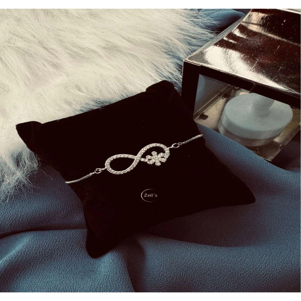 Zell’s Infinity Sparkle Bracelet with Floral Accent – Silver Elegance